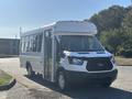 A 2017 Ford Transit-350 shuttle bus with a white exterior and an open door at the front, designed for passenger transport