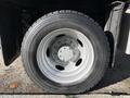 A close-up of a wheel and tire from a 2008 Ford F-550 showcasing the rim and tread pattern