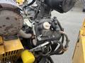 Close-up of a 2014 Vermeer Corporation Sweep Stump Cutter engine showing the Kohler motor components and hoses connected to the machinery