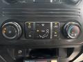 Control panel of a 2017 Ford F-550 featuring buttons for air conditioning ventilation fans and climate settings