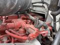 Red engine components of a 2011 Ford F-650 with visible hoses and wiring