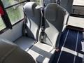 Interior view of a 2013 International CE300 school bus showing two gray seats with seat belts