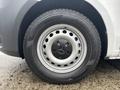 Close-up of a wheel of a 2021 Mercedes-Benz Metris featuring a silver alloy rim with multiple circular holes and a black tire with the name HERCULES and size details visible
