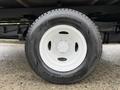 White tire with black tread on a silver wheel from a 2019 Ford Econoline