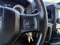 Steering wheel of a 2015 RAM 4500 featuring controls for cruise control and a keychain dangling from the ignition