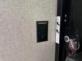 A black power outlet mounted on a textured gray wall in a 2021 Jayco Jay Flight interior