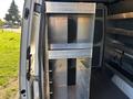 A metal shelving unit designed for a 2024 Mercedes-Benz Sprinter 2500 with multiple compartments and a sleek industrial finish