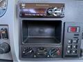 Dashboard of a 2019 Peterbilt 337 featuring a radio control unit and climate control knobs with an empty storage compartment below