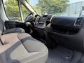 Interior view of a 2017 RAM Promaster showcasing the driver's seat dashboard and control panel with black upholstery and simple controls