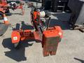 2021 Wallenstein Wx540-0RA tow behind industrial log splitter featuring a red frame and a large splitting wedge at the front with a handle and controls mounted on the side