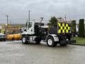 A 2016 Freightliner 108SD truck with a rear-mounted tool bed and black and yellow checkered safety signage