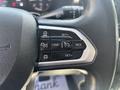 Close-up of the steering wheel controls of a 2022 RAM Promaster 350 featuring buttons for cruise control settings and adjustment options