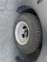 A close-up of a tire mounted on a wheel of a 2020 Chevrolet Express showing tread patterns and a metal rim