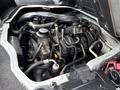 Engine compartment of a 2009 Toyota Hiace showing various components such as the engine block hoses and electrical connections