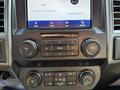 Dashboard controls of a 2022 Ford F600 featuring audio and climate control buttons along with a touchscreen display