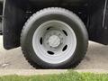 Close-up of a gray wheel on a 2020 Ford F-550 showing the tire tread and hubcap design
