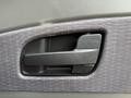 Close-up of the interior door handle of a 2012 International TerraStar resembling a rectangular design with a smooth black finish and textured grip area