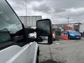 A 2013 Ford F-250 SD with chrome side mirrors and a white exterior is parked with other vehicles in the background