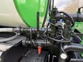 Close-up of hydraulic valves and hoses on a green and black 1996 Kenworth T800 showing various fittings and a manual control lever