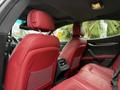 Interior of a 2016 Maserati Ghibli featuring red leather seats and headrests with a modern design