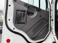 The door panel of a 2016 Freightliner 108SD featuring a gray interior finish with a plastic pocket and a handle