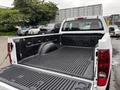A 2011 Chevrolet Colorado with an empty truck bed and a black liner visible inside the cargo area