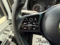 The steering wheel of a 2022 Mercedes-Benz Sprinter featuring control buttons for cruise control and a textured grip