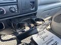 A 2004 Ford F-750 vehicle interior with a built-in cup holder extended from the dashboard