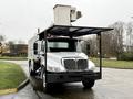 A 2020 International MV607 truck with a flatbed and mounted equipment on top designed for utility or maintenance work