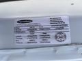 2019 GMC Savana with a vehicle information label showing specific details about weight and modifications