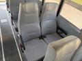 Interior view of two gray padded seats from a 2009 International 3000 CE school bus with a simple ribbed design