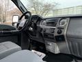 Interior view of a 2012 Ford F-550 showcasing the steering wheel dashboard and center console with controls and storage compartments