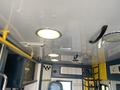 Interior view of a 2011 Chevrolet Express showing a ceiling with lights and a ventilation system along with seating and grab bars