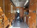 Interior of a 2008 Workhorse W62 vehicle showing wooden cabinets with various storage compartments and tools arranged neatly along the sides