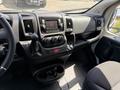 The interior dashboard of a 2021 RAM Promaster featuring a central control panel with audio system and air conditioning dials alongside a steering wheel and driver's seat