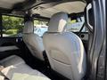 Interior view of a 2021 Jeep Gladiator showing two front seats with light gray upholstery and a black interior design