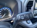 Close-up of a 2023 Ford Bronco Sport steering wheel controls featuring settings for wipers and turn signals with a speedometer in the background