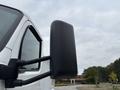 Close-up of the side mirror of a 2025 Peterbilt 536 featuring a sleek black design and sturdy arm assembly