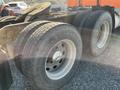 Close-up of the rear tires of a 2009 Peterbilt Highway truck showcasing the tread pattern and wheel rims