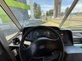Interior view of a 2012 Ford Econoline with a steering wheel dashboard gauges and control panel visible