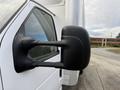 Close-up of the side mirror on a 2022 Ford E-450 showing its black design and clear visibility for driving safety