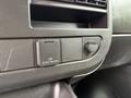 Control panel of a 2021 Chevrolet Express featuring an outlet and a dial for adjusting settings