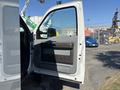 A 2011 Ford F-550 with the driver's side door open revealing the interior and dashboard area
