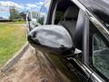 A 2014 Honda Odyssey with a focus on its side mirror and front profile