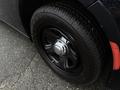 Close-up of a black 2017 Dodge Charger wheel featuring a chrome center cap and black tire with a prominent tread pattern