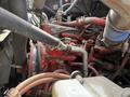 Close-up of the engine components of a 2016 Freightliner 108SD showing various pipes and fittings in red and silver with visible wear and age details