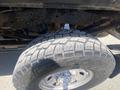 A close-up of a large off-road tire and wheel from a 2016 Ford F-350 SD showing deep treads and metallic rim detailing