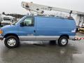 A blue 2006 Ford Econoline van with a silver stripe and a mounted lift mechanism on the roof