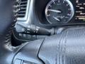 A close-up of the steering wheel controls of a 2018 Toyota Highlander showing the headlight and wiper controls on the left side