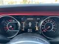 Dashboard of a 2021 Jeep Wrangler featuring speedometer and tachometer displays with engine temperature and odometer readings